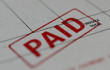Paid stamp on an invoice document.