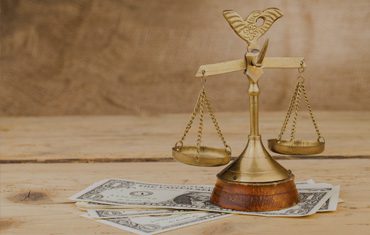 Scales of justice on dollar bills.