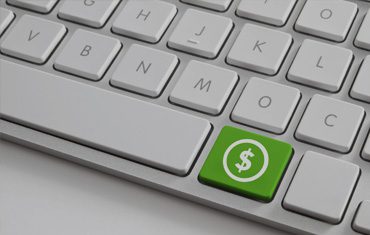 Keyboard with green money symbol key.
