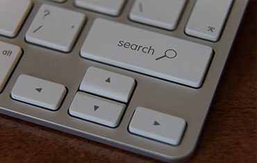 Keyboard with search and arrow keys.