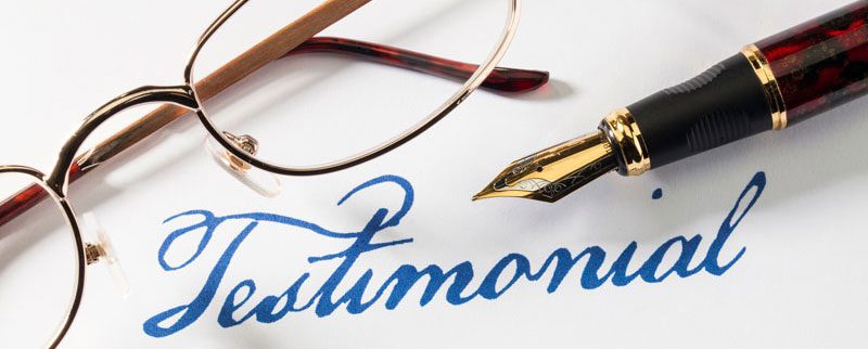 Fountain pen, glasses, and “Testimonial” text.
